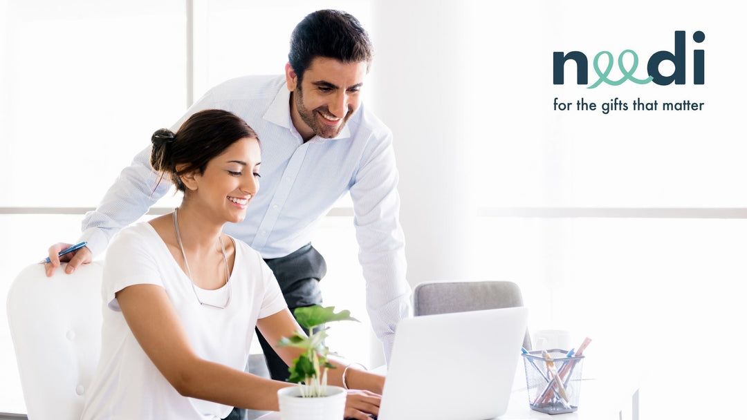 A happy worker showing her boss her latest project in an open and light office